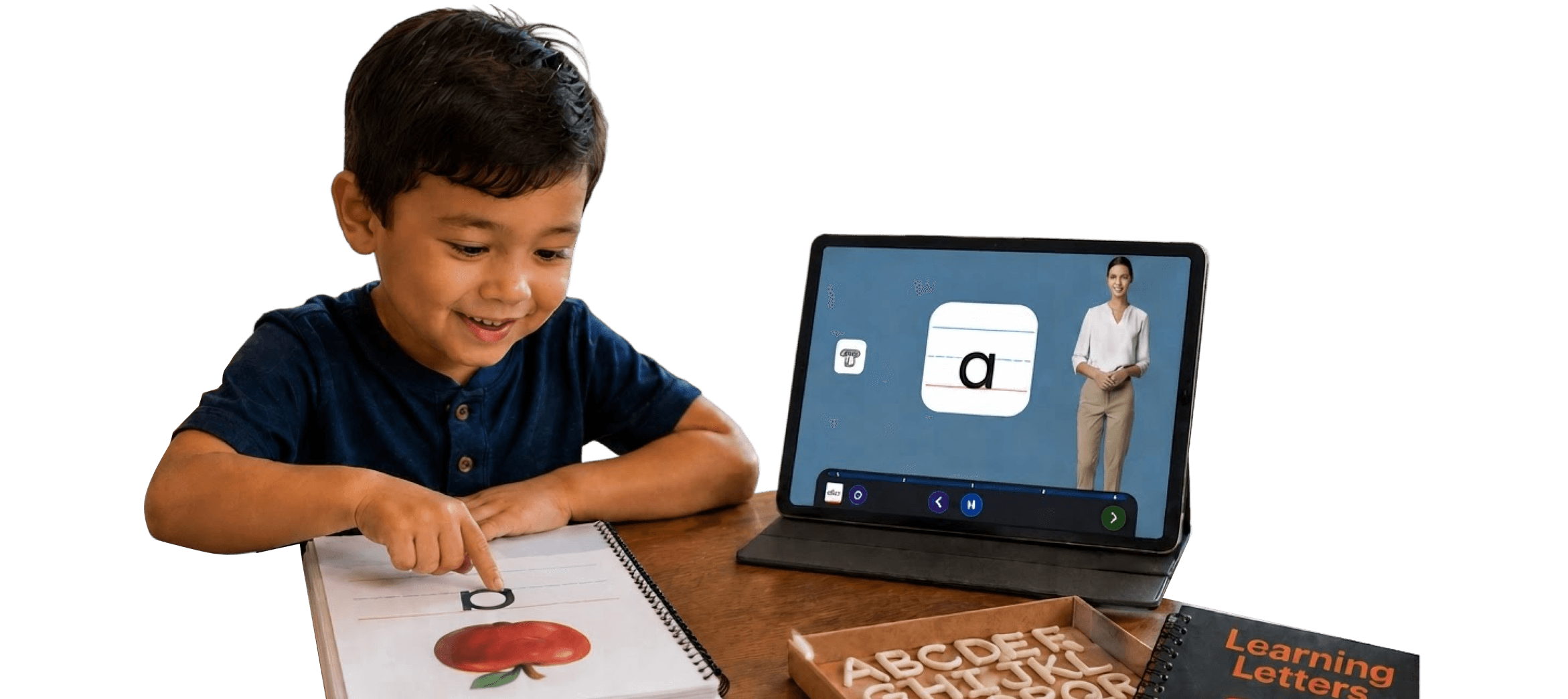 A child tracing a letter in a workbook beside a tablet lesson and alphabet clay letters