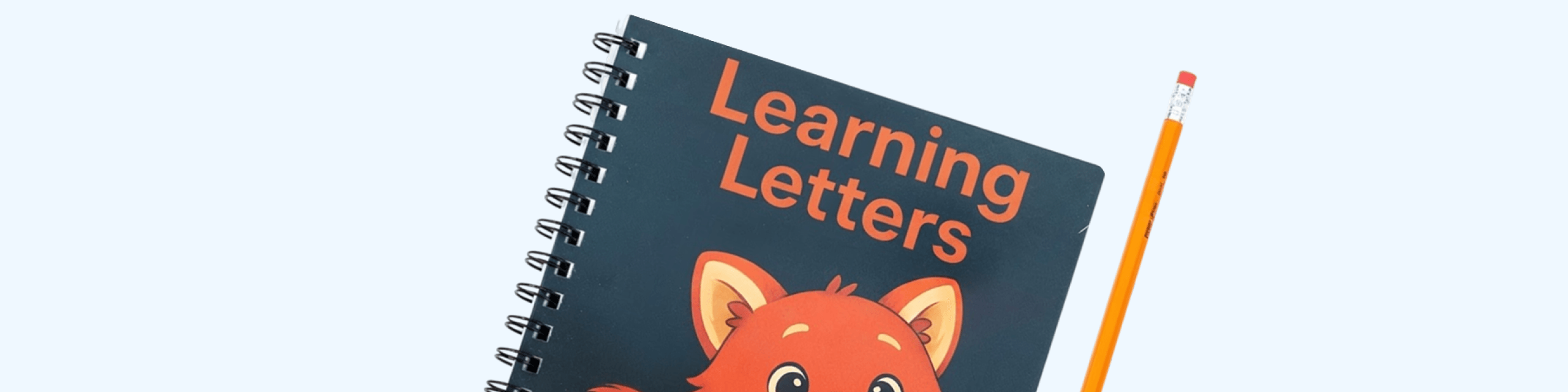 The Learning Letters workbook lying next to a pencil