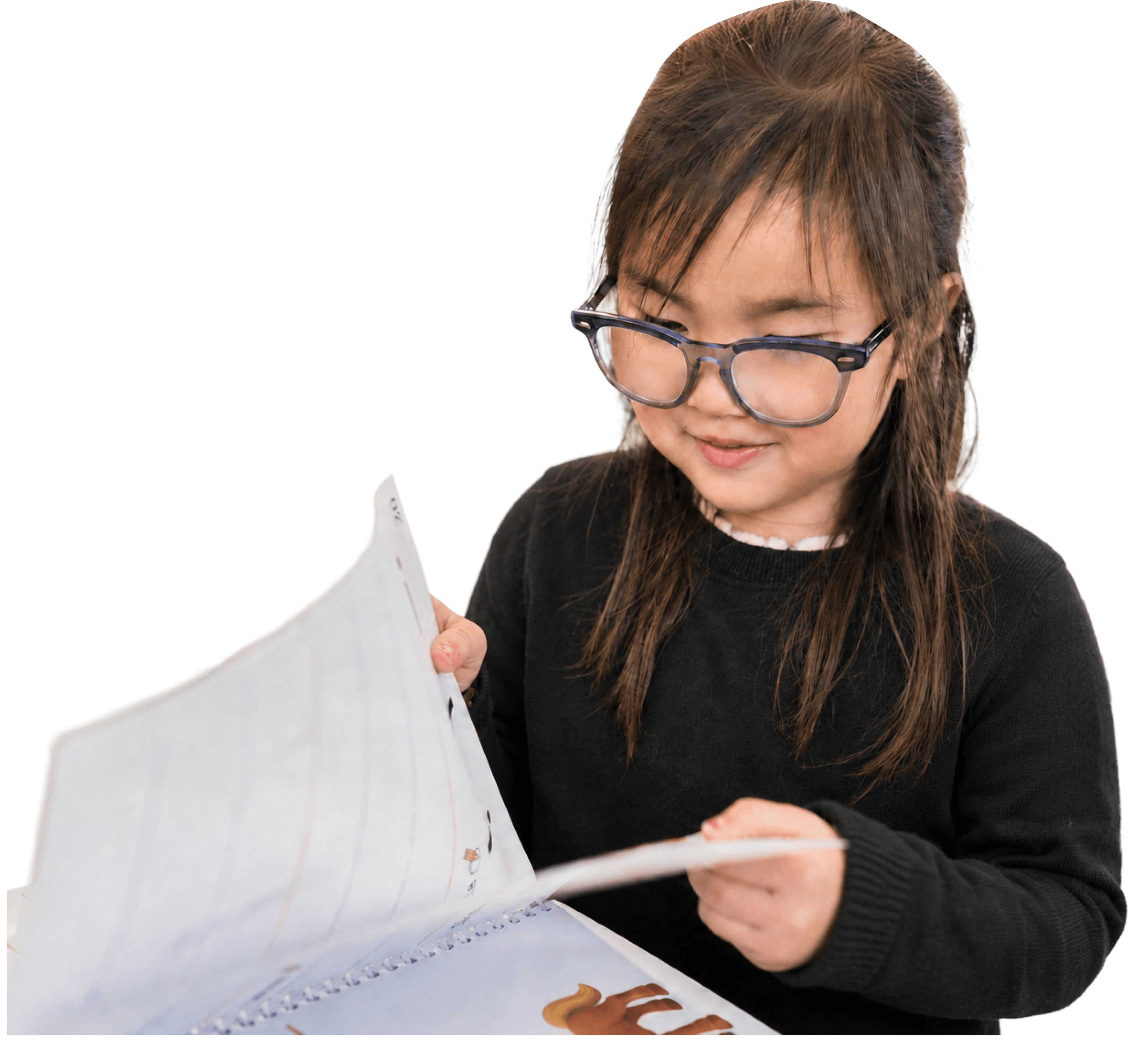 A child flipping through a workbook