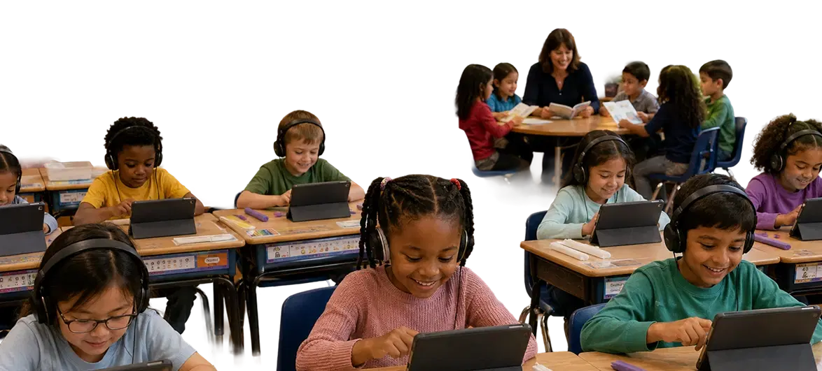 A teacher reading with a small group of students while other students use tablets at their desks